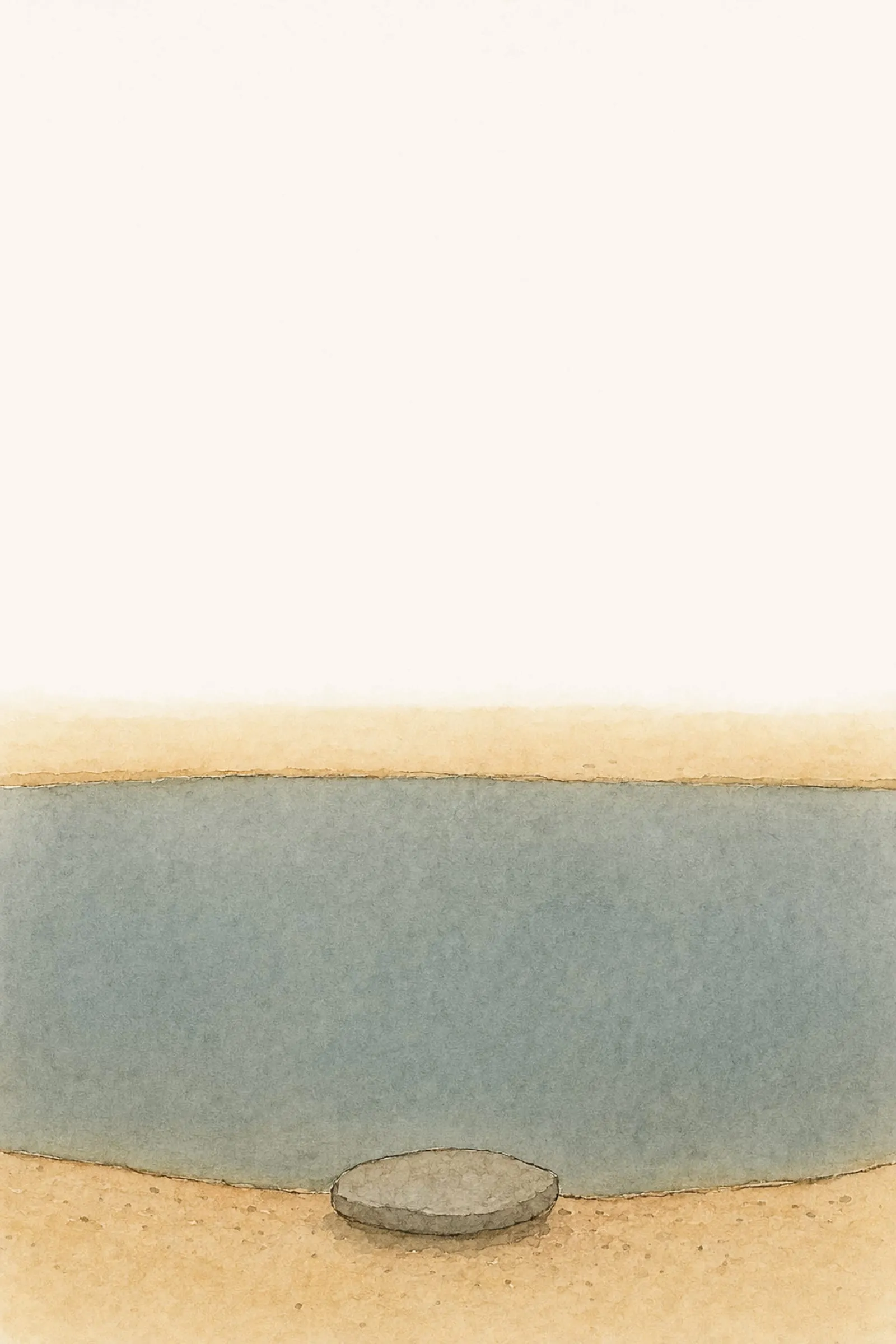 The flat grey stone sits empty beside the pool, whose grey water is unbroken from one edge to the other, quiet and holding.